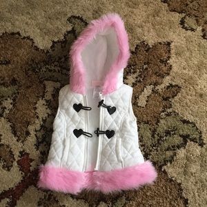 Quilted puffy vest with pink fur details.